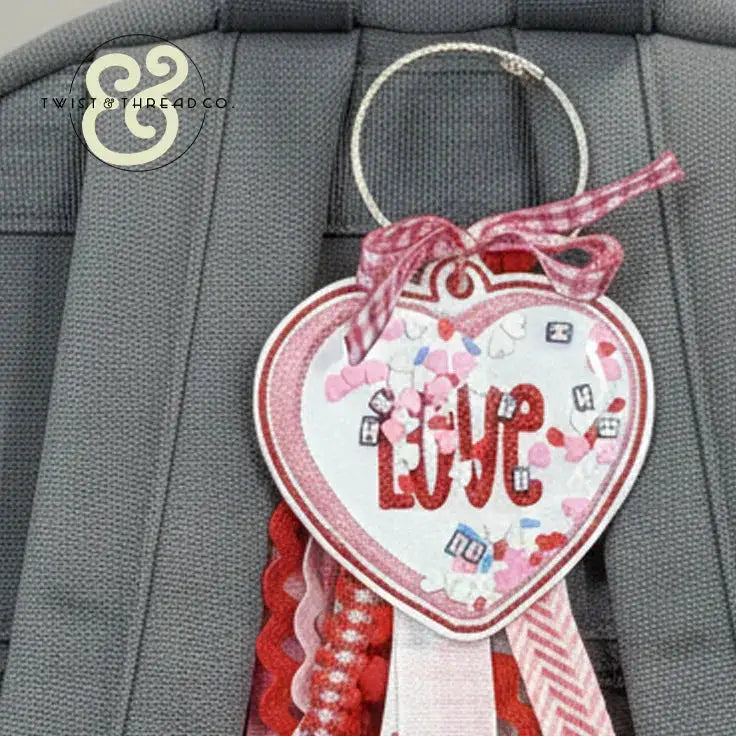 Embroidered heart-shaped LOVE keychain with red and pink ribbons by Twist & Thread Co.