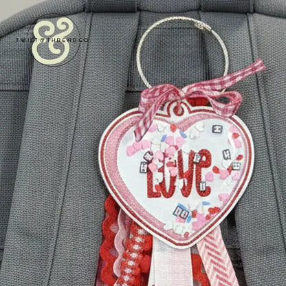 Embroidered heart-shaped LOVE keychain with red and pink ribbons by Twist & Thread Co.