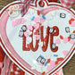 Embroidered heart-shaped LOVE patch with confetti, mini envelopes, and pink gingham ribbon by Twist & Thread Co.