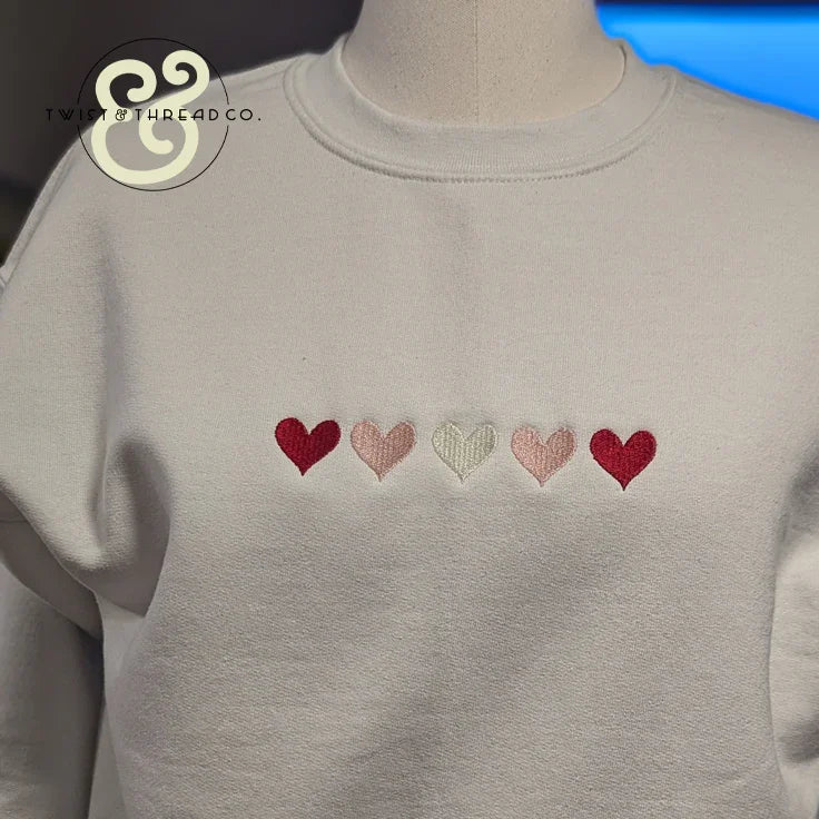 White sweatshirt with embroidered red and pink hearts, Twist & Thread Co. premium apparel