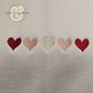 Embroidered hearts on white fabric, Twist & Thread Co. custom apparel design
