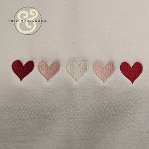 Embroidered hearts on white fabric, Twist & Thread Co. custom apparel design