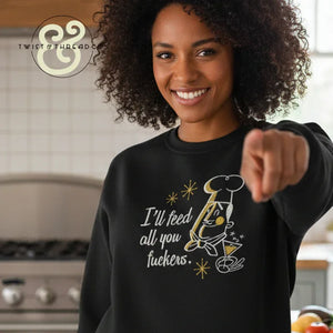 Smiling woman wearing a black embroidered sweatshirt with a chef graphic and the phrase 'I'll feed all you' in kitchen