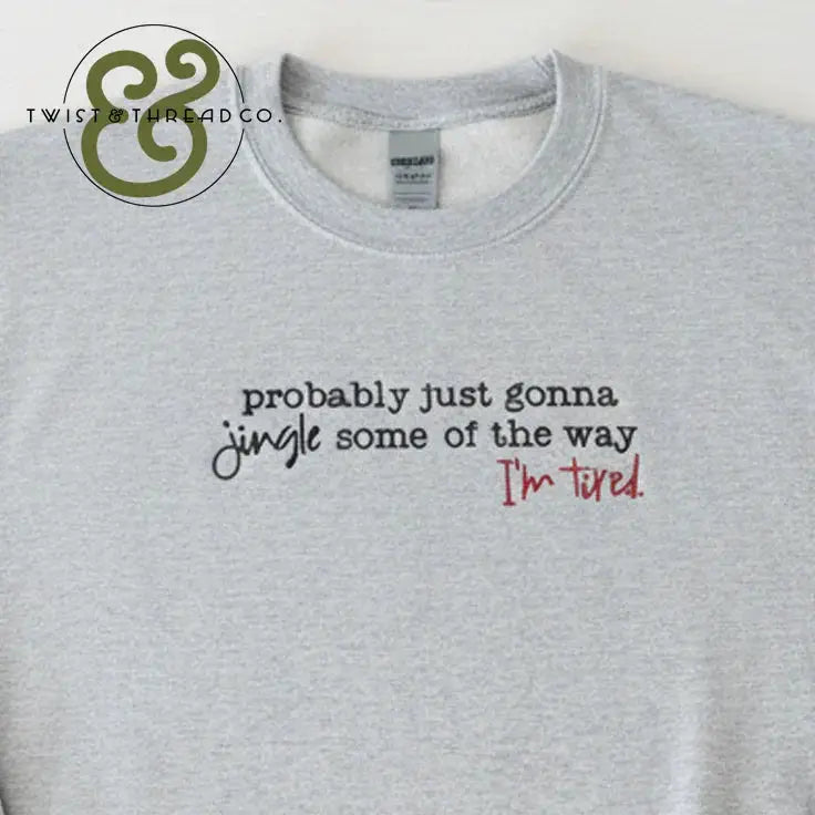 Gray sweatshirt with text saying 'probably just gonna jingle some of the way I'm tired' in black and red fonts