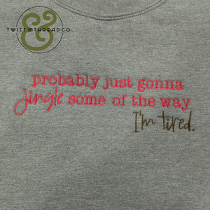 Grey fabric with red and brown embroidered text reading 'probably just gonna jingle some of the way I'm tired'