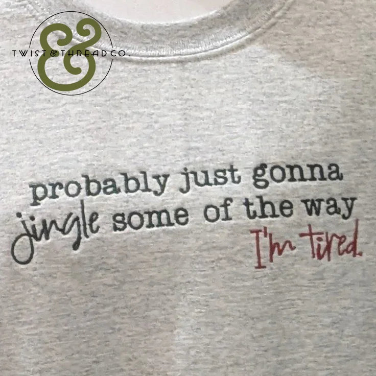 Gray shirt with the phrase "probably just gonna jingle some of the way I'm tired" printed in black and red text