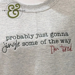 Gray shirt with the phrase "probably just gonna jingle some of the way I'm tired" printed in black and red text