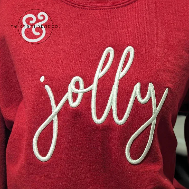 Red sweatshirt with white embroidered cursive text 'jolly' and Twist & Thread Co. logo