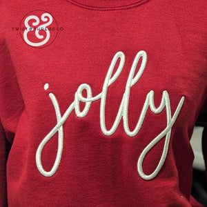 Red sweatshirt with white embroidered cursive text 'jolly' and Twist & Thread Co. logo