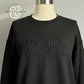 Black sweatshirt with embossed text Just a Little Ray of Pitch Black displayed on mannequin