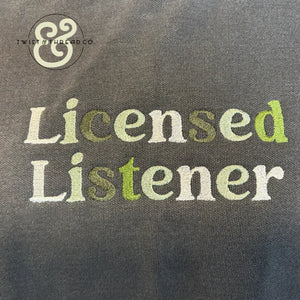 Gray fabric with embroidered text 'Licensed Listener' in white and green thread, Twist & Thread Co. logo