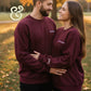 Couple wearing matching maroon embroidered sweatshirts from Twist & Thread Co. outdoors