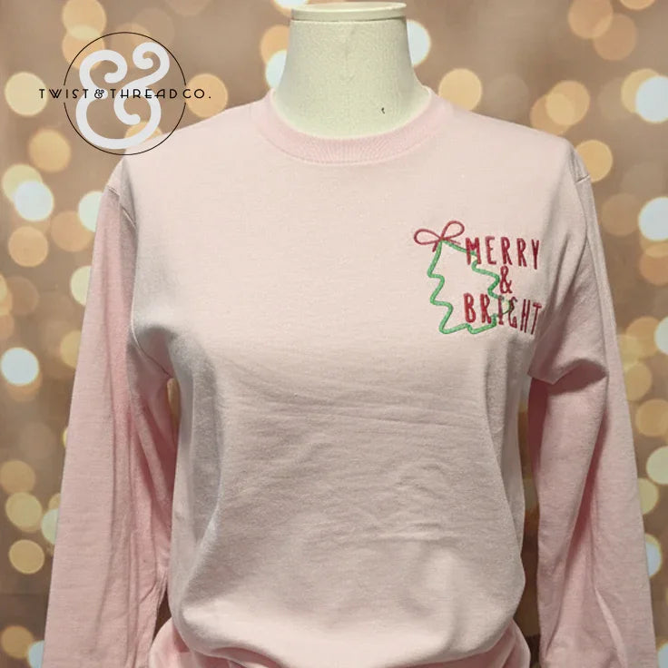 Light pink Christmas sweatshirt with 'Merry & Bright' and green tree design, Twist & Thread Co.
