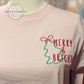 Pink sweatshirt with embroidered green Christmas tree and red 'Merry & Bright' text