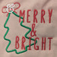 Embroidered Merry & Bright text with green Christmas tree outline on fabric
