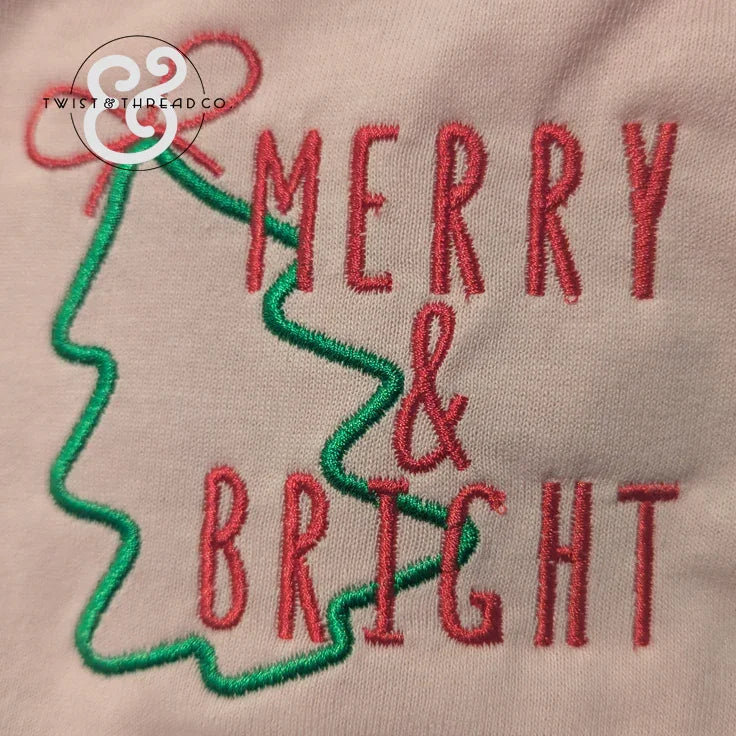 Embroidered Merry & Bright text with green Christmas tree outline on fabric