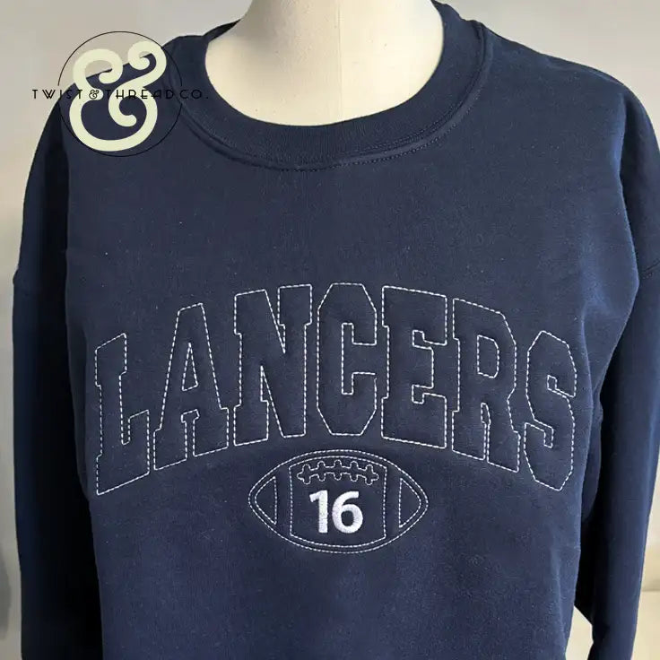 Navy blue crewneck sweatshirt with ’lancers’ and a football graphic embroidered in white thread