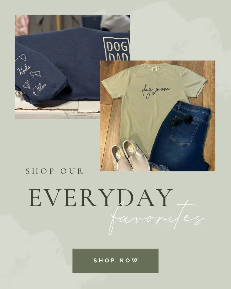 Navy blue t-shirt with white embroidered dog names and a ’dog dad’ logo on the chest