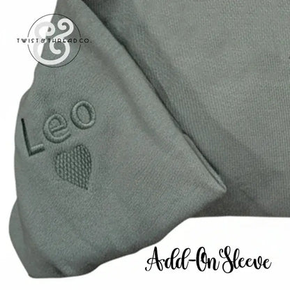 Gray fabric add-on sleeve with embroidered name Leo and heart detail from Twist & Thread Co.