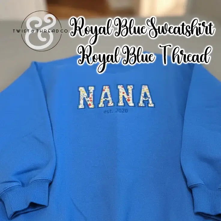 Royal blue sweatshirt with floral applique letters spelling NANA and est. 2020 embroidery