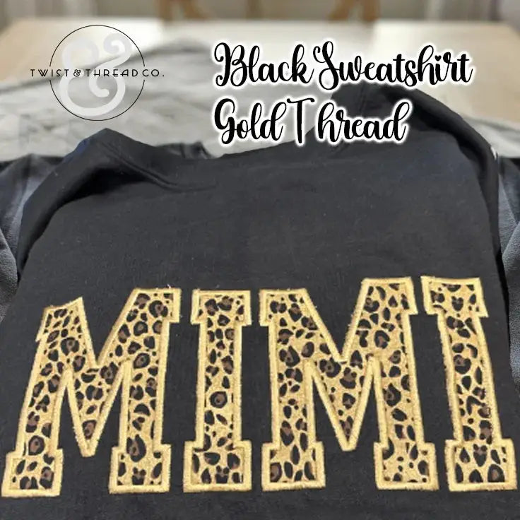 Black sweatshirt with the word MIMI embroidered in gold thread featuring leopard print applique design