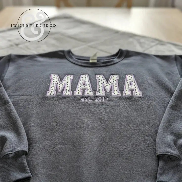 Gray sweatshirt featuring polka dot applique letters spelling MAMA with est. 2012 embroidery on chest