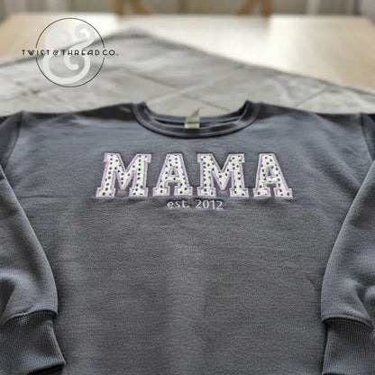 Gray sweatshirt featuring polka dot applique letters spelling MAMA with est. 2012 embroidery on chest