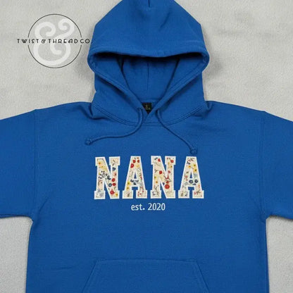 blue hoodie with floral applique letters spelling NANA and est. 2020 on front by Twist & Thread Co