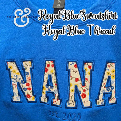 Royal blue sweatshirt with floral applique letters spelling NANA and est. 2020 embroidered