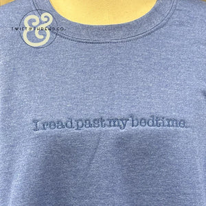 Grey sweatshirt with embroidered text reading 'I read past my bedtime.' casual cozy apparel