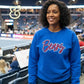 Woman wearing blue Bears embroidered sweatshirt by Twist & Thread Co. at indoor sports arena