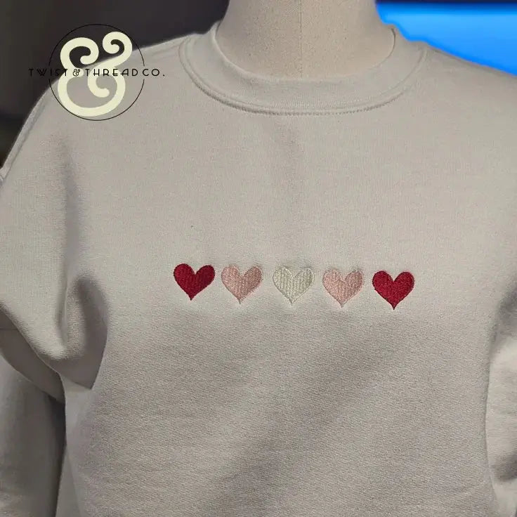 White sweatshirt with embroidered red and pink hearts, Twist & Thread Co. premium apparel