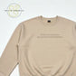 Beige sweatshirt with text 'That sounds like my husband's problem' laid flat on white background