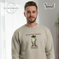 Man wearing sand-colored sweatshirt with cartoon frog in cowboy boots and hat, text 'The only squat I'm doing is diddly'