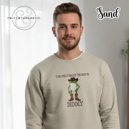 Man wearing sand-colored sweatshirt with cartoon frog in cowboy boots and hat, text 'The only squat I'm doing is diddly'