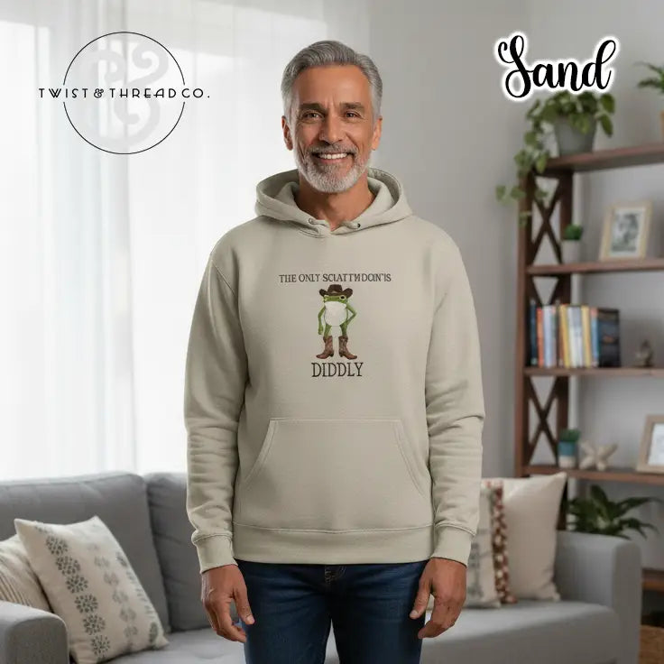 Sand-colored hoodie with cartoon frog wearing boots and hat, text saying 'The only sciatomdoin's diddly'