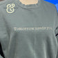 Custom embroidered sweatshirt with 'Tomorrow needs you' text by Twist & Thread Co.