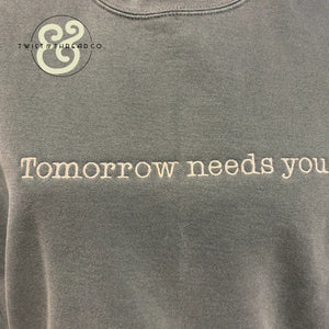 Custom embroidered hoodie with 'Tomorrow needs you' text by Twist & Thread Co.