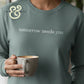 Custom embroidered hoodie with 'tomorrow needs you' text, Twist & Thread Co. branding, person holding mug