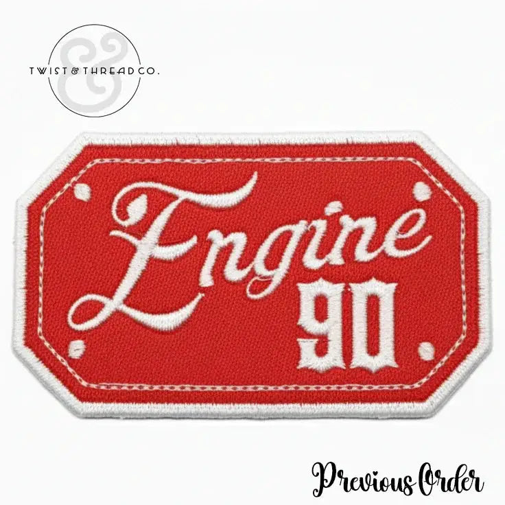 Red embroidered patch with white border featuring text Engine 90 in stylized font
